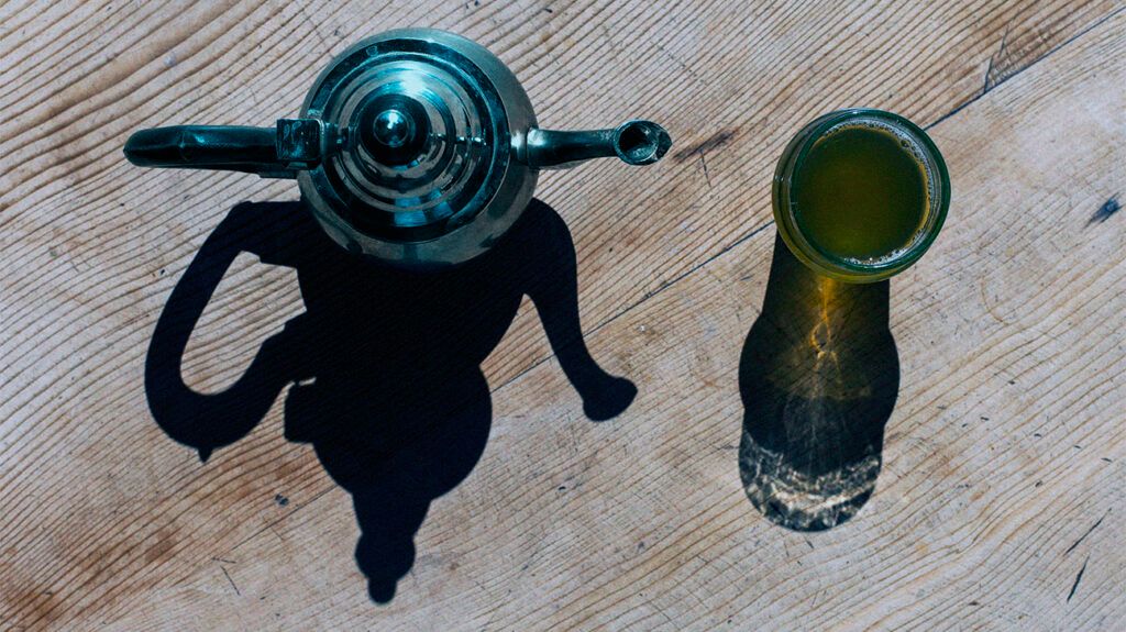 pot and cup of green tea seen from above