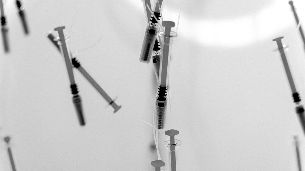 black and white photo of syringes