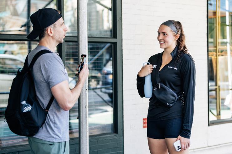 Mark Langowski talks to a woman on the street.