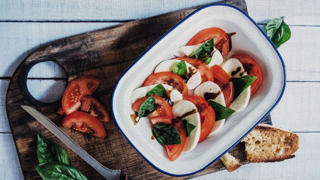 salad bowl with tomatoes, mozzarella, and basil