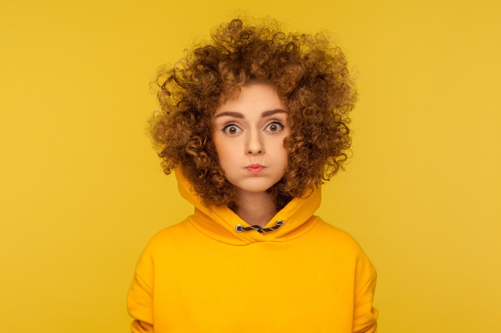 There are a few ways to achieve the mammalian diving reflex, including holding your breath as you press a bag of frozen vegetables against your face. Here, a woman in a yellow hoodie holds her breath.