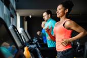 A workout program should include cardiovascular exercise, strength training, flexibility work and stability exercises. Here, a woman runs on a treadmill.