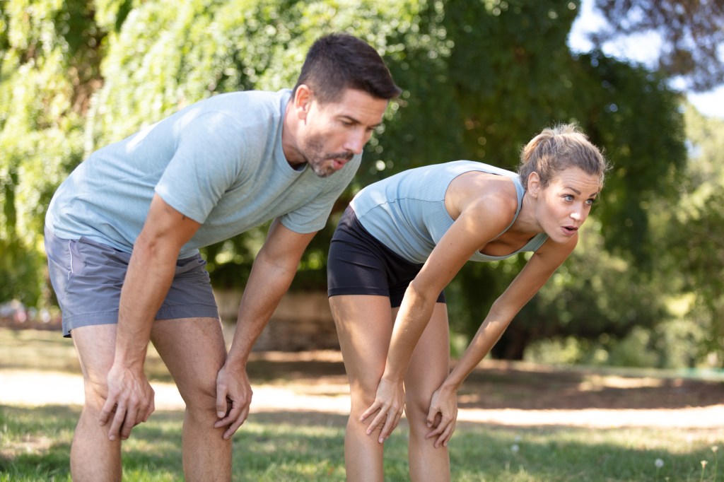 Athletes bending over to rest after exercising