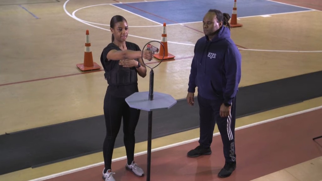 Police academy recruit working out her trigger finger as part of the NYPD's physical fitness test.