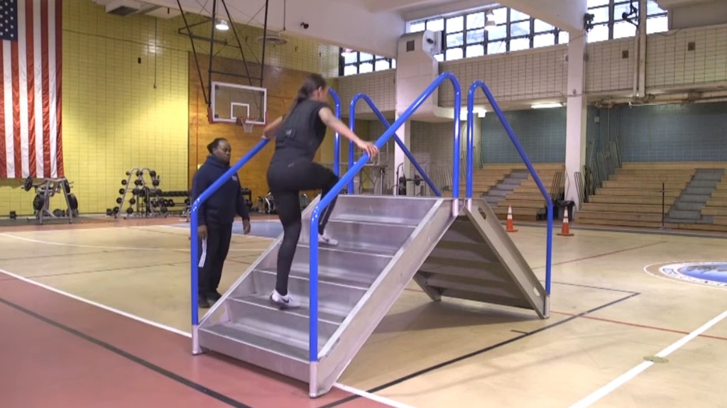 Police academy recruit climbing stairs as of the NYPD's physical fitness test.