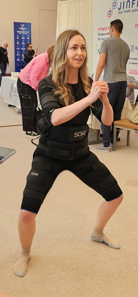 biohacker-world-conference-102005666 The SQAI Power Suit (pictured here) sends electrical impulses to muscles. Here, a woman squats as she wears it.